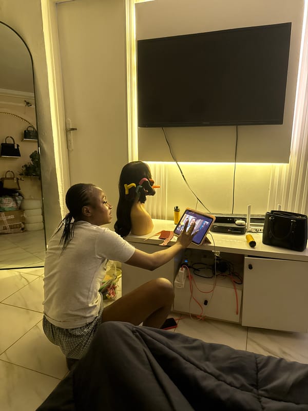 Quiet evening at home in Abuja with snacks, screens, and shelves