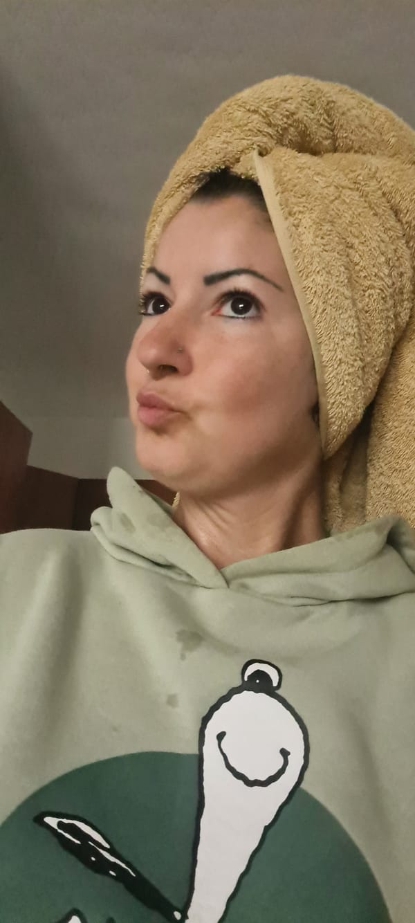 Woman applies skincare during morning routine in Nahariyya