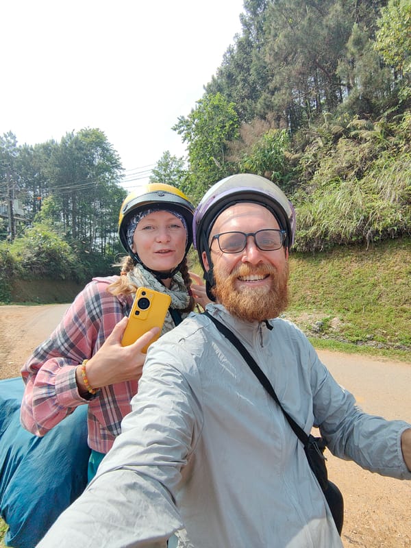 Motorcycle riders travel through rural Vietnamese mountain road