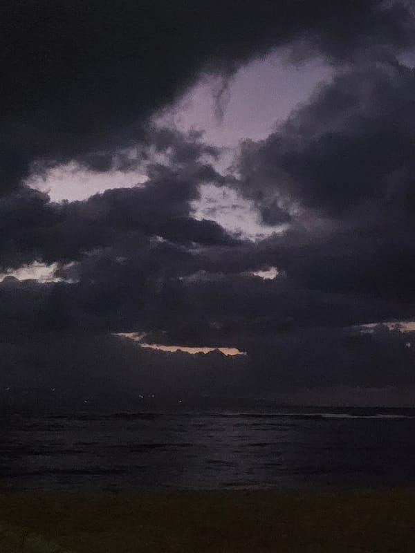 Storm clouds gather over Denpasar beaches at dusk