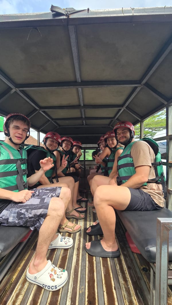 Group in safety gear rides open truck through Ubud streets