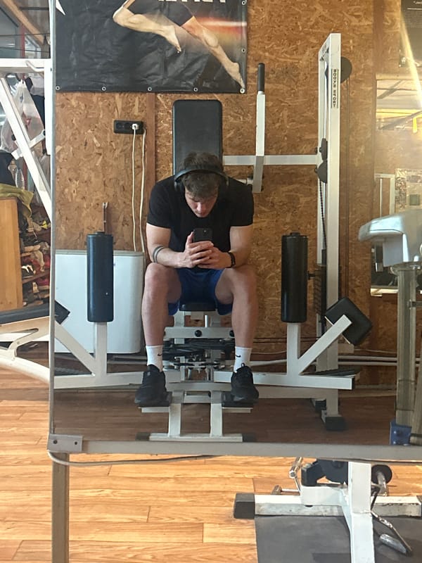 Man uses phone while exercising at Bulgarian gym