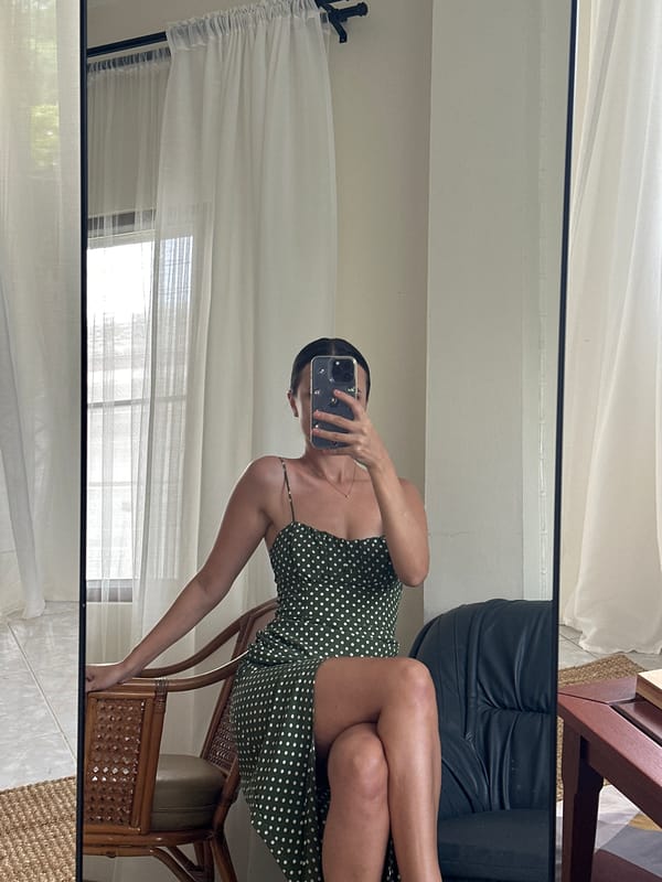 Mirror selfie in a Baan Mae Nam bedroom, green polka-dot dress