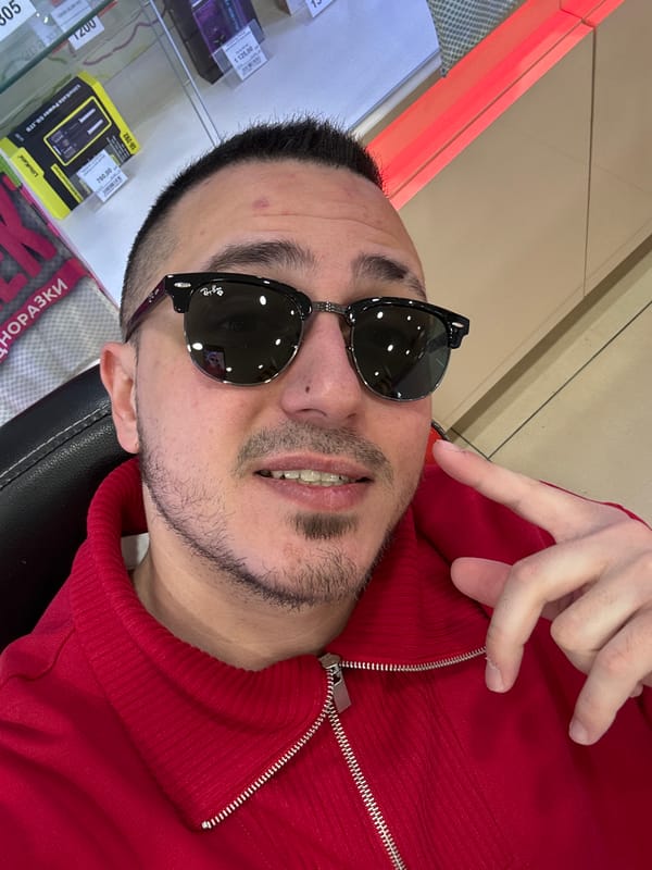 Man in red sweater shops at display case in Saint Petersburg