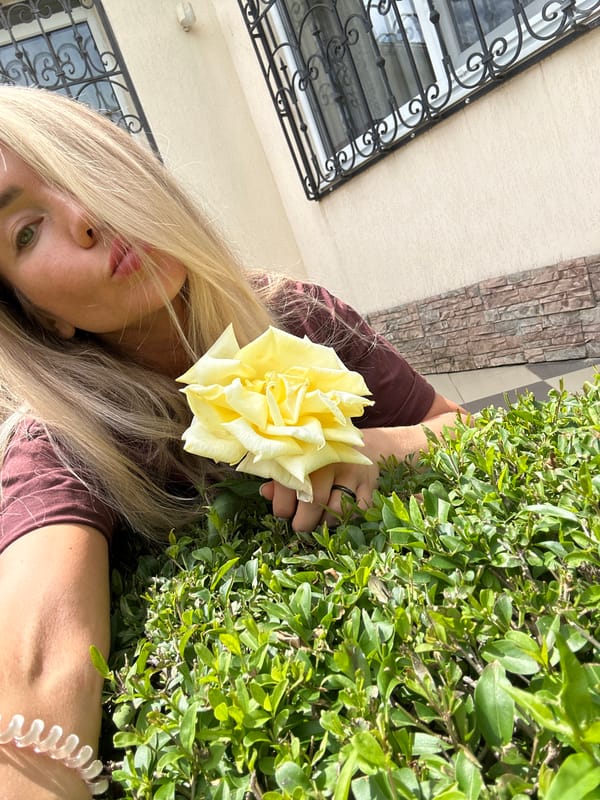 Woman photographs garden morning session in Armavir, Russia