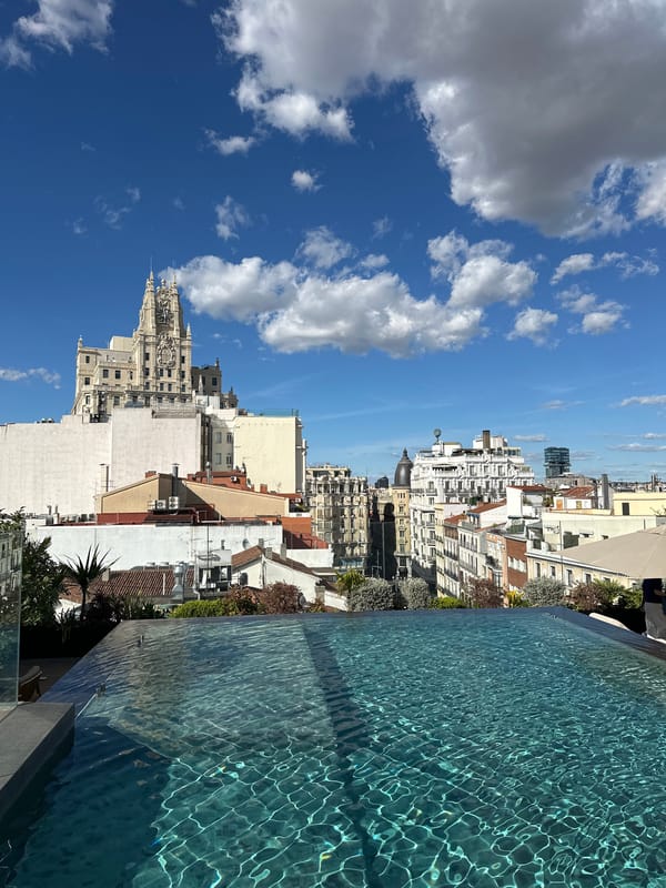 Rooftop pool overlooks Madrid on sunny afternoon