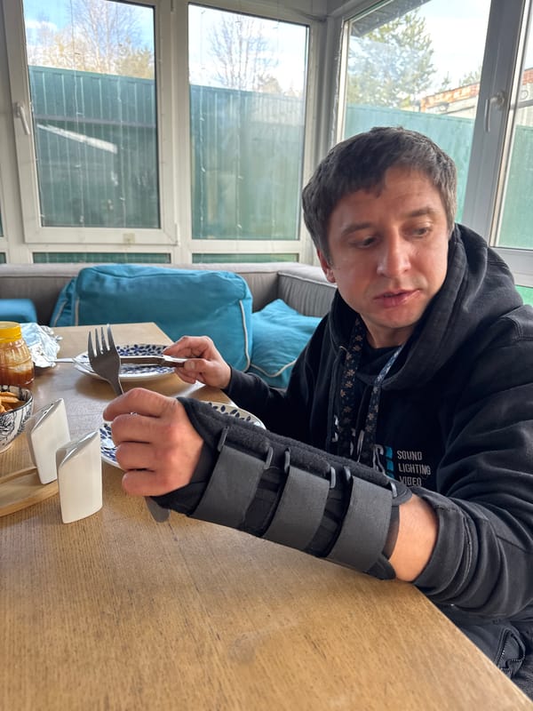 Man enjoys meal with puppy in Ptichnoye, Russia
