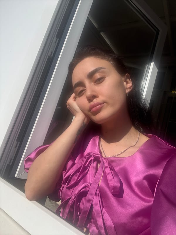 Woman in pink photographed multiple times in Tbilisi setting