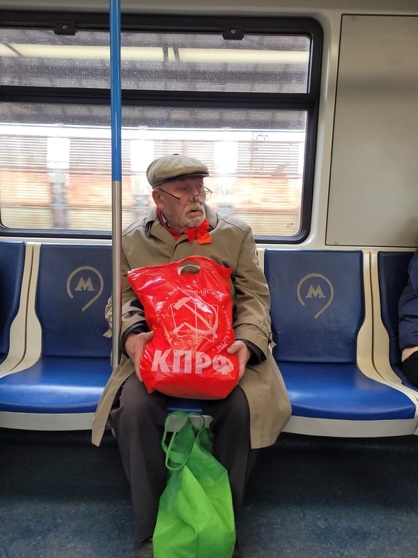 Elderly passenger with Soviet-themed bag observed on Moscow subway