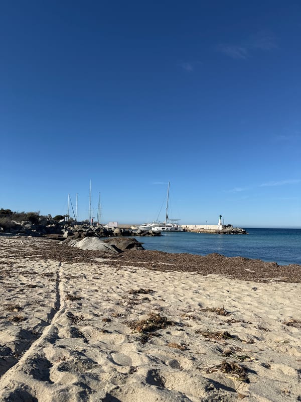 Clear skies and footprints mark quiet afternoon at Lumio beach