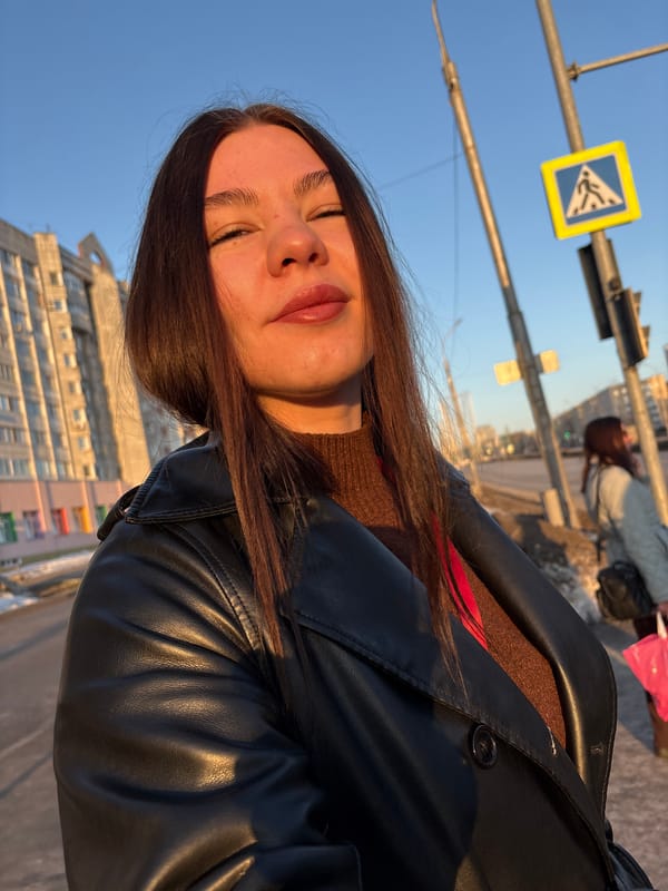 Woman takes selfies wearing Russian energy lanyard in Perm