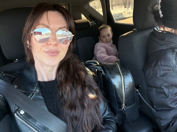 Woman and baby photographed in car backseat in Perm