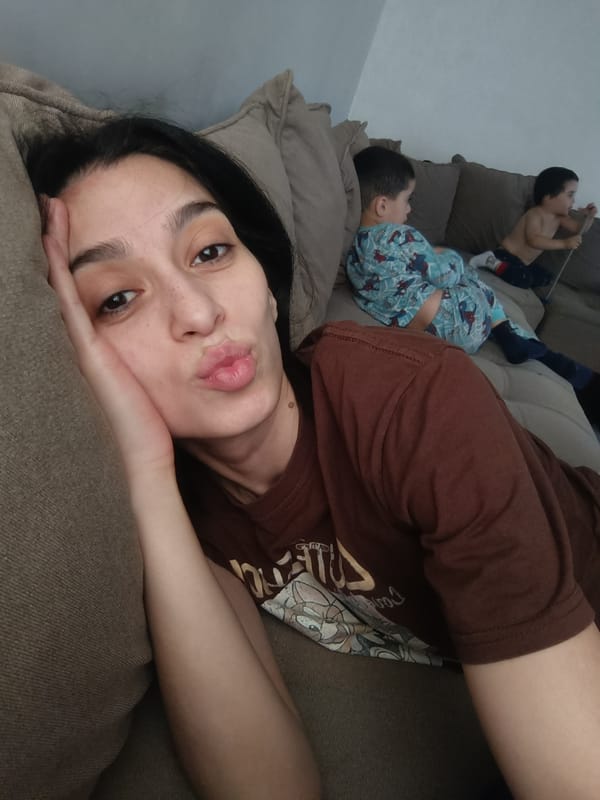 Woman rests on couch with children in Simferopol home