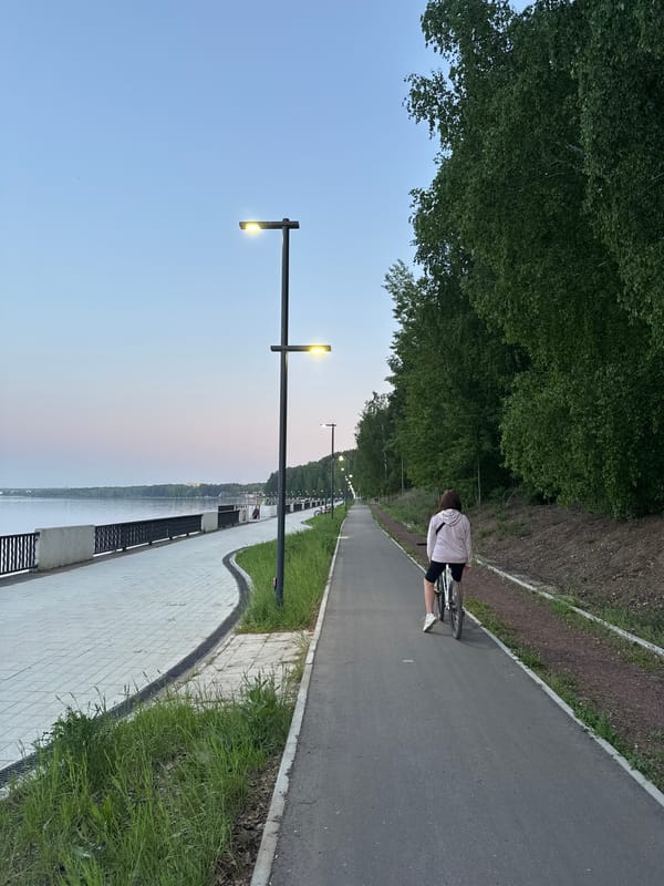 Cyclist spotted on riverside path in Chaikovsky, Russia