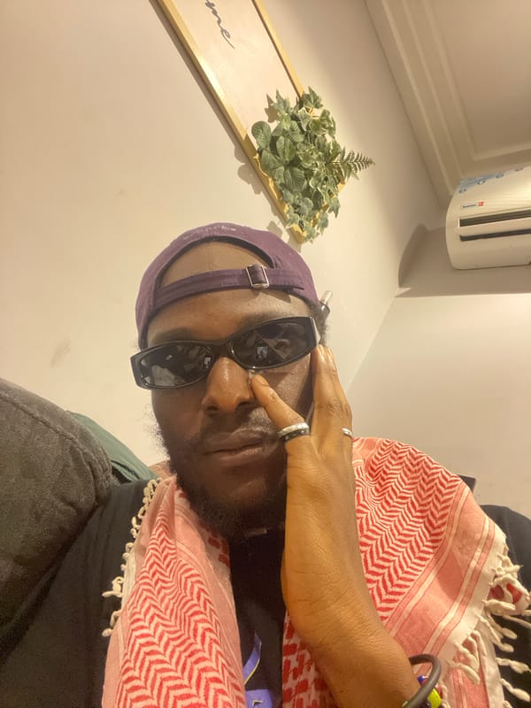 Evening hangout in an Abuja living room, phones and laptops out