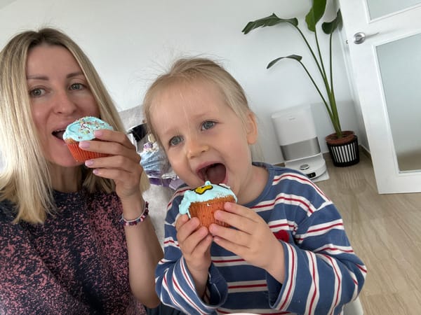 Woman and child pose upside down with cupcakes in València