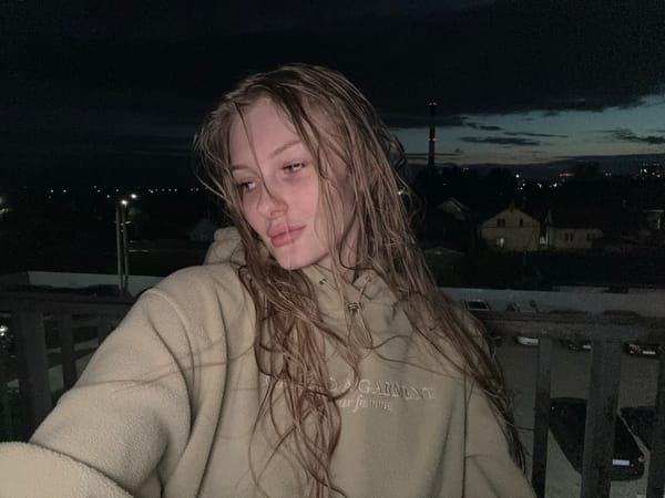 Woman captures dusk selfies on balcony in Kondratovo, Russia