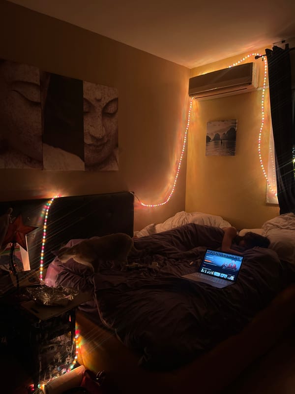 Person uses laptop in bed during evening in Barcelona
