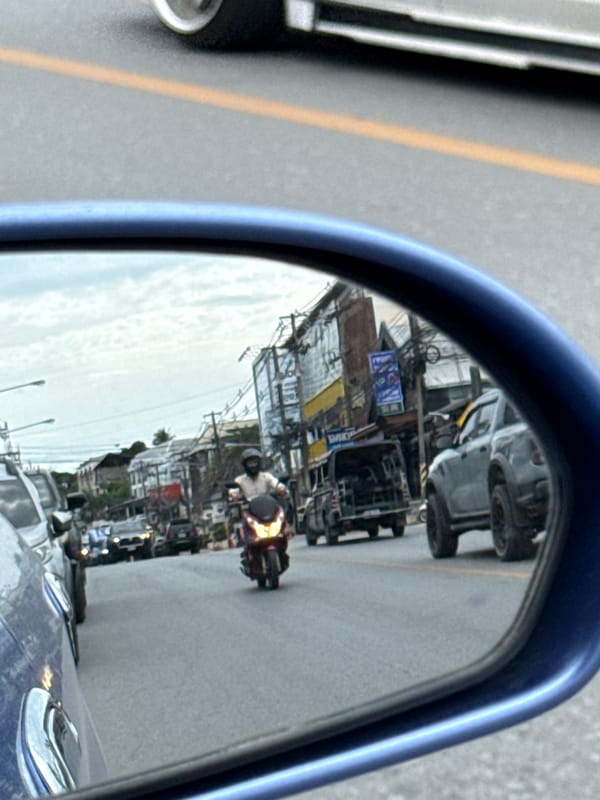 Morning traffic and a Lotus's billboard on Ko Samui streets