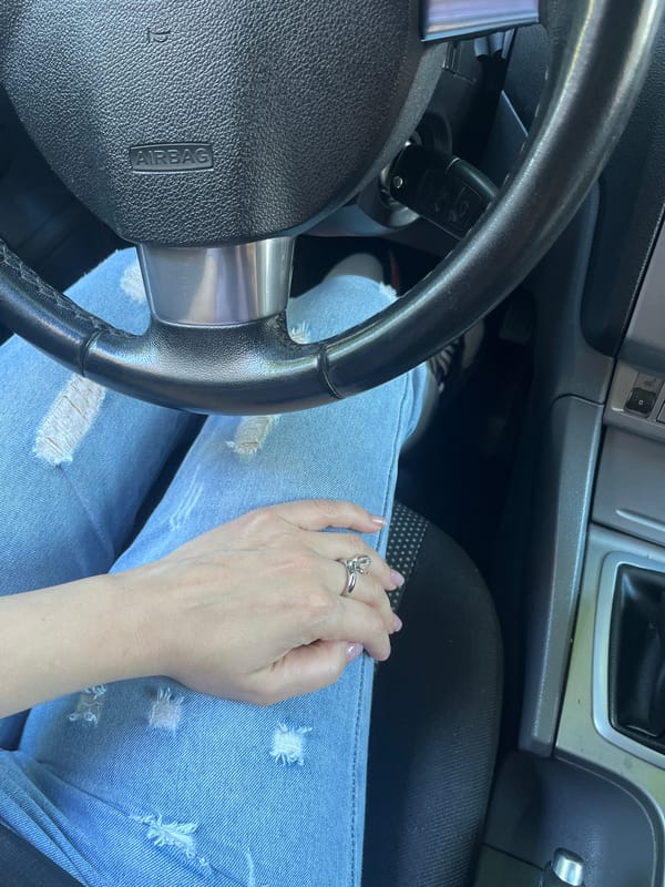 Silver ring, denim, and a quiet moment in a Voronezh car