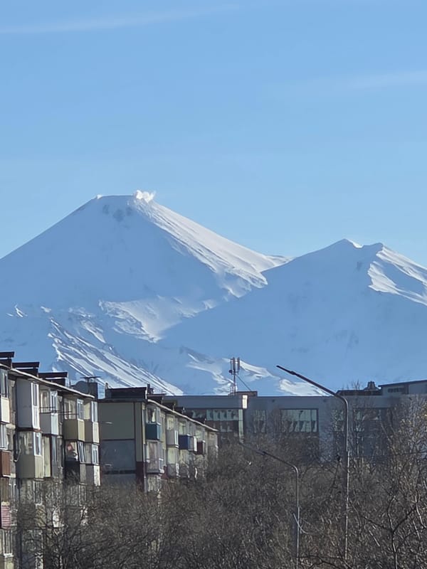 Urban scenes documented in mountainous city with snowy backdrop