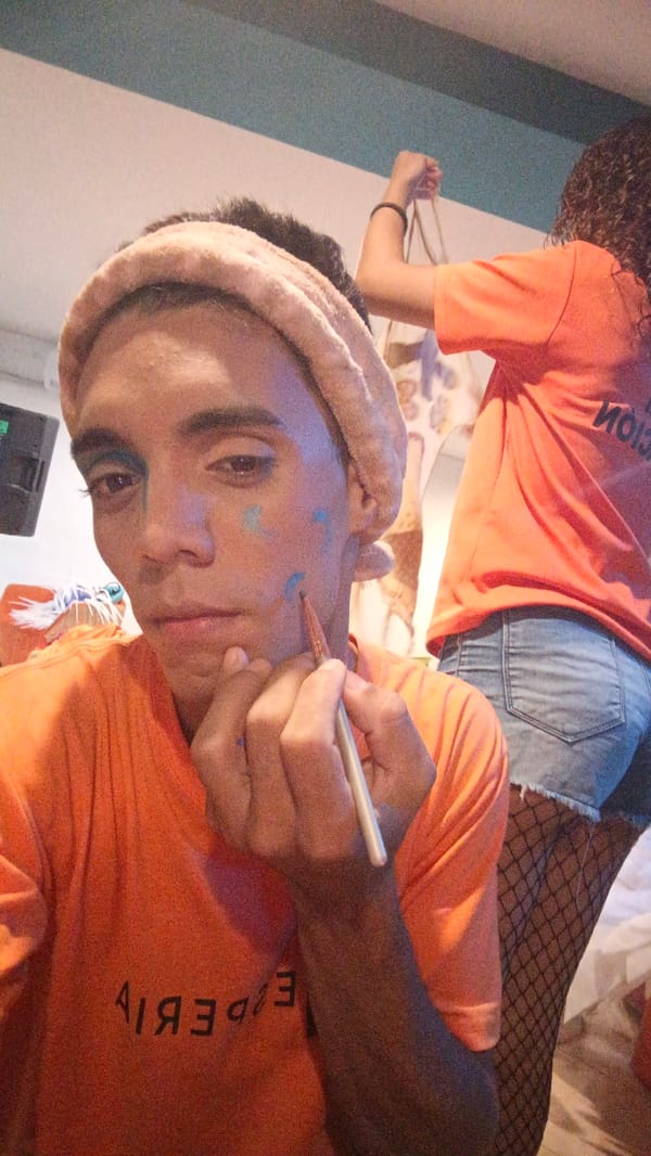 Person applies colorful face paint in Venezuelan beach town