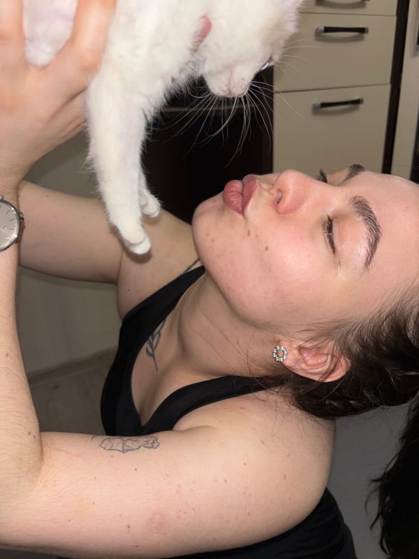 Woman enjoys yoga session with kitten in Perm apartment