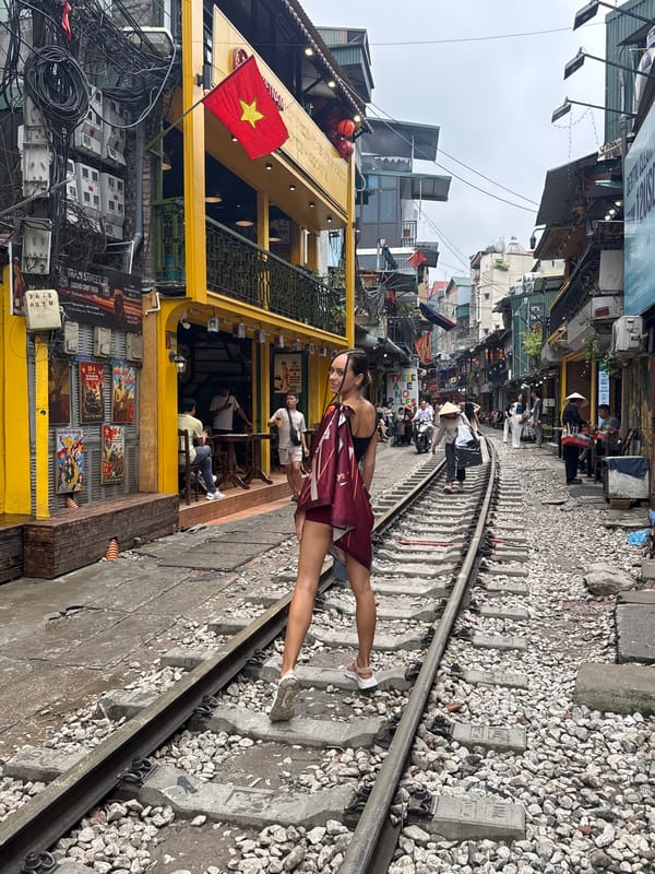 Tourists take selfies on Hanoi's famous Train Street tracks
