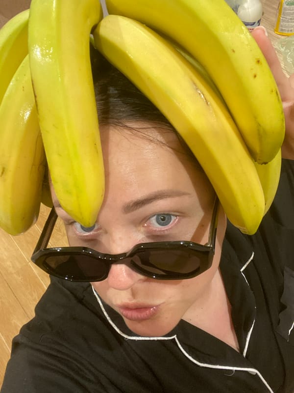 Person poses with bananas on head during Sochi rainstorm