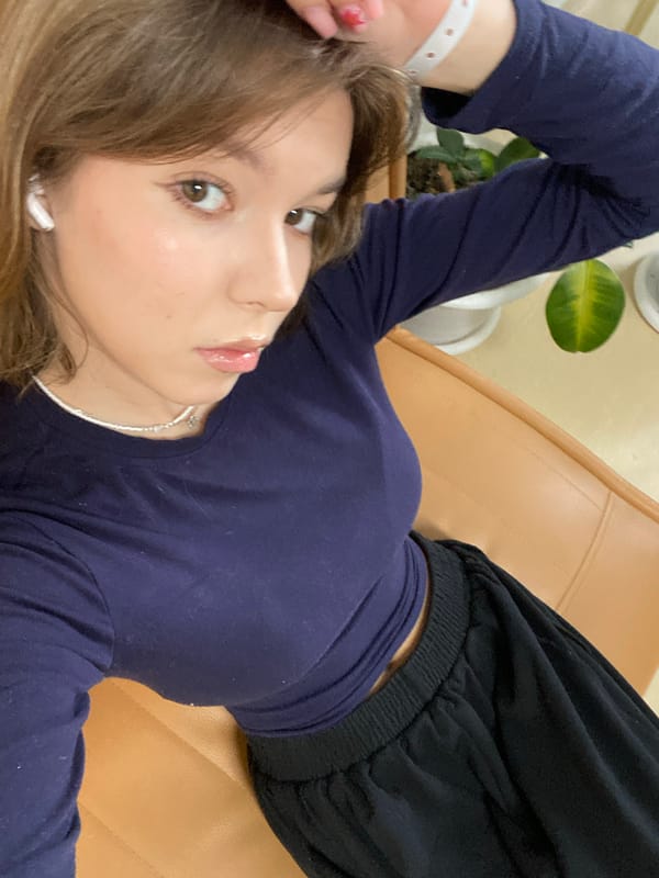 Woman relaxes on couch in plant-filled room in Perm