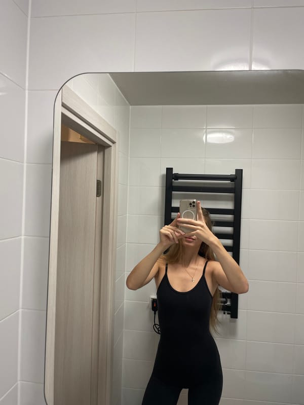 Woman takes bathroom mirror selfies in Khimki, Russia