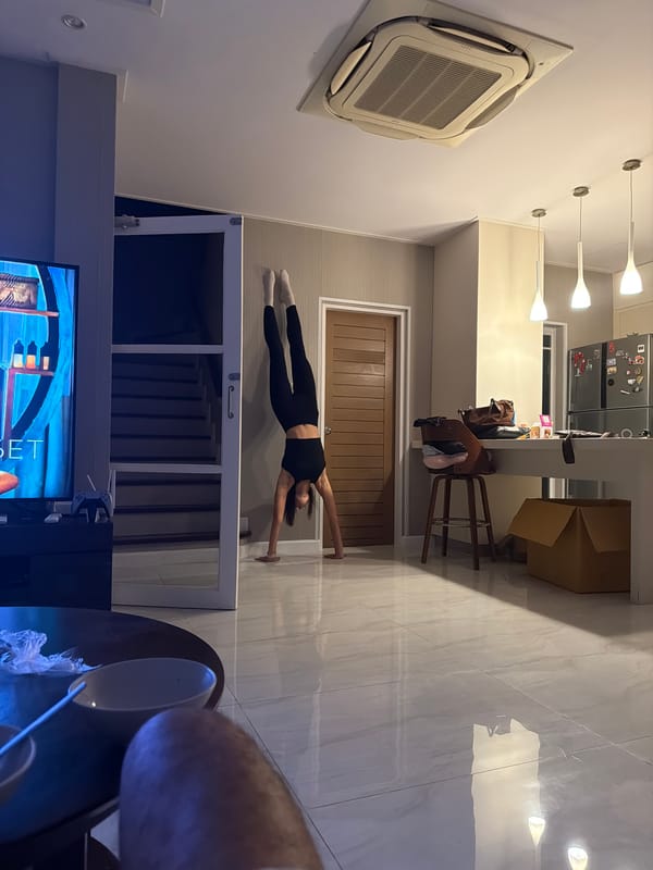 Woman performs split exercise in Chalong home