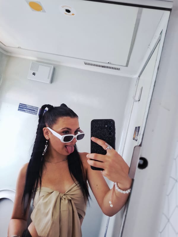 Woman takes playful selfie in transport restroom near Karlukovo