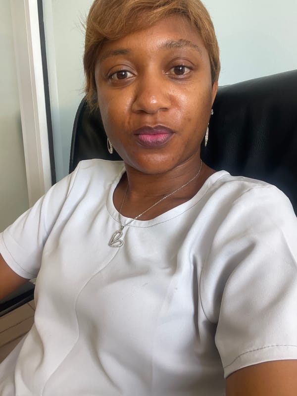 Woman in white shirt observed seated in Jos, Nigeria