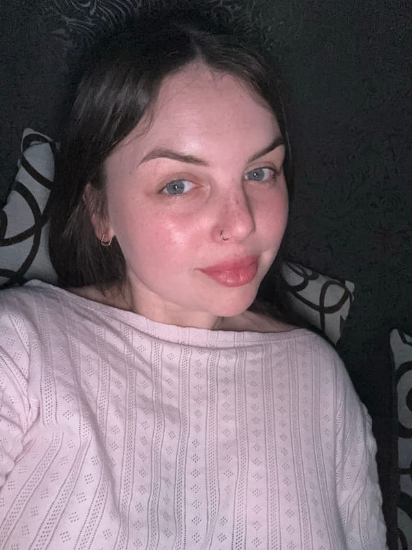 Person rests on sofa while watching YouTube in Ukrainian town