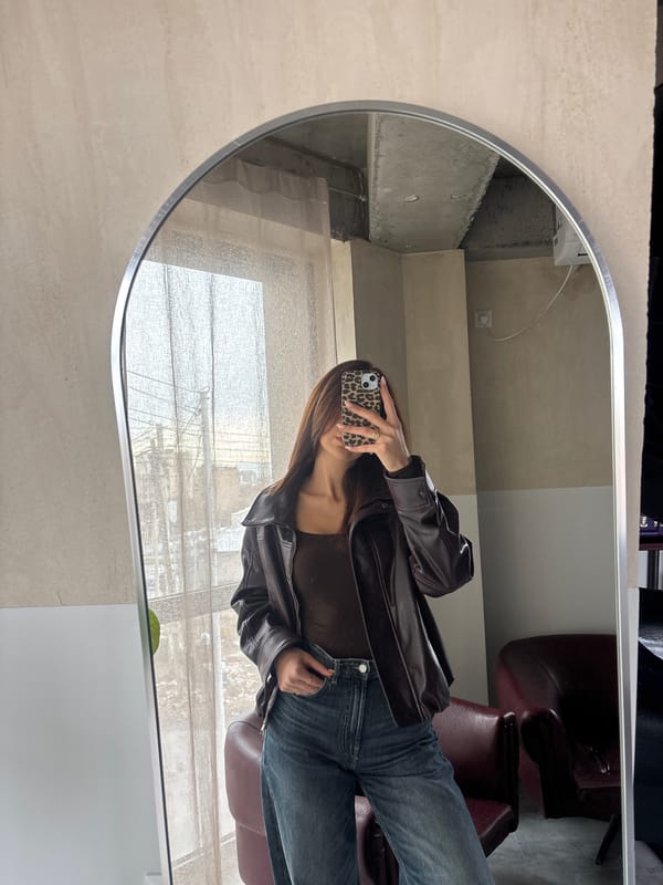 Woman takes morning selfies in brown leather jacket, Yerevan