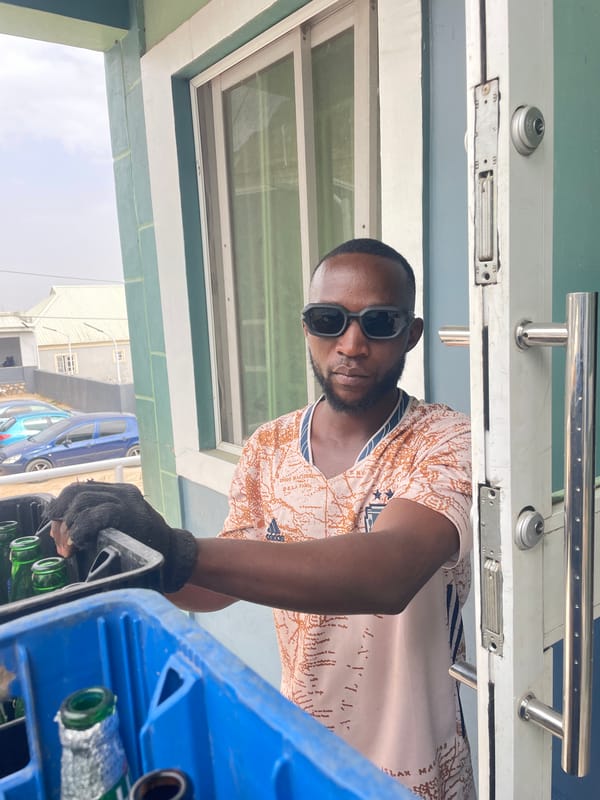 Man carries crate of bottles in Gura Top