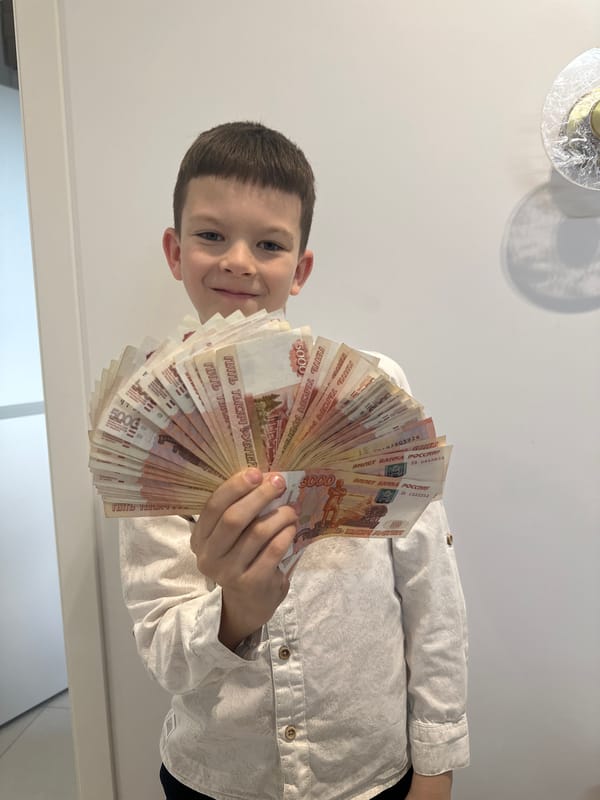 Boy displays cash, dog rides passenger seat in Прикамский