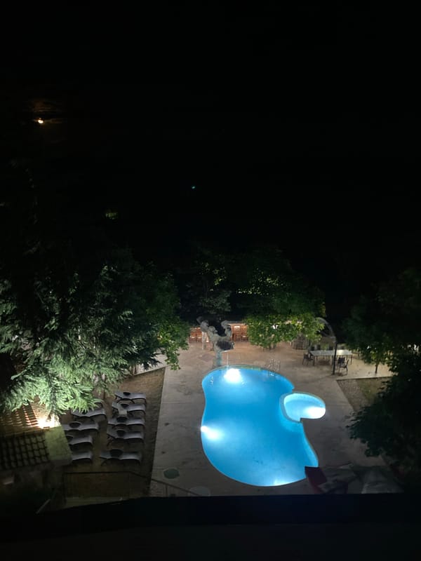 Glowing kidney-shaped pool lit up at night in Sredets