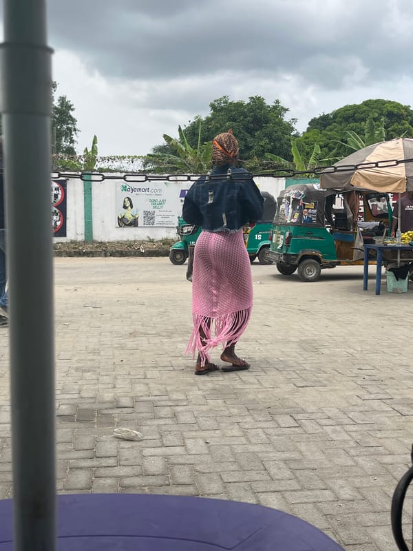 Elderly woman walks pathway in Lekki, Nigeria
