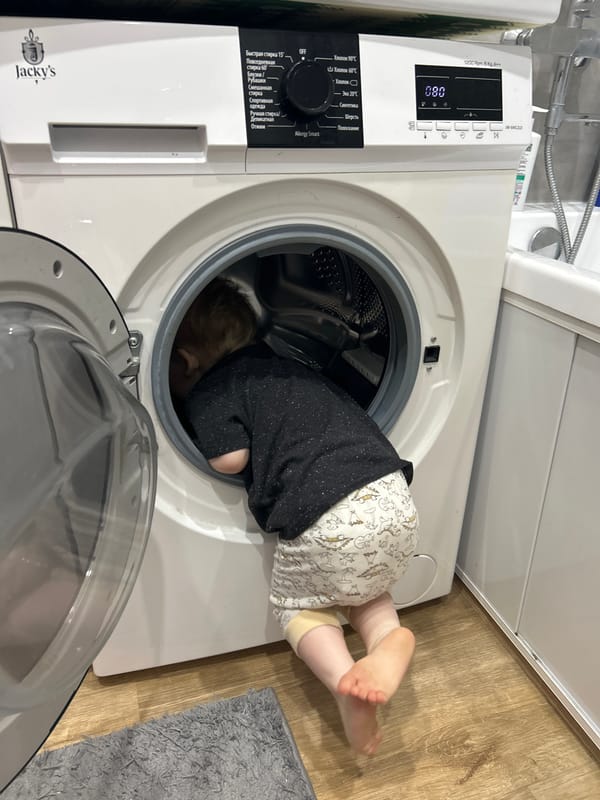 Family playtime documented in Chaikovsky home, child explores washing machine