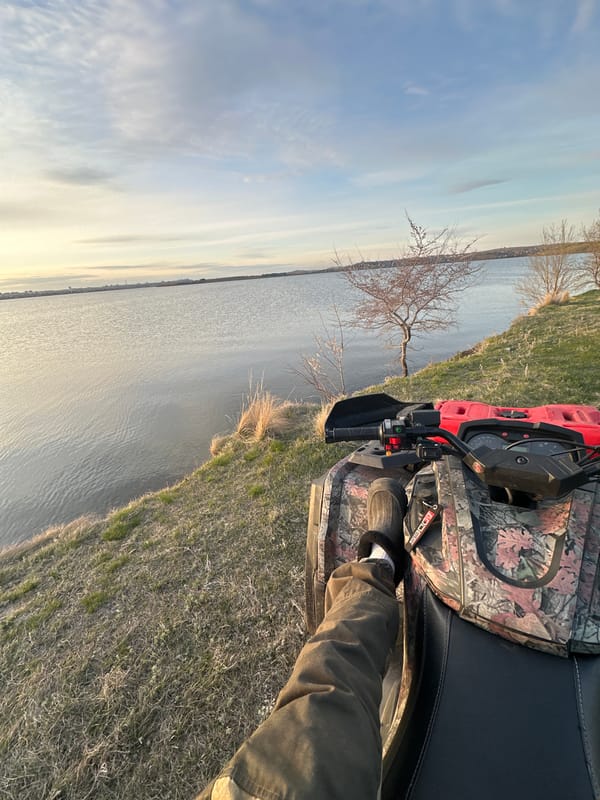 Recreational outing near water documented with ATV and sunset