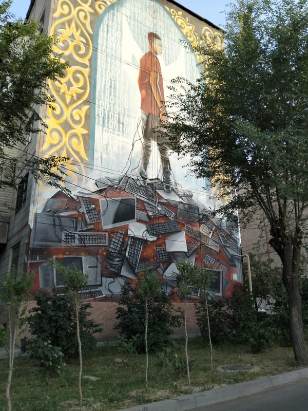 Almaty neighborhood murals, street vendors, and urban construction