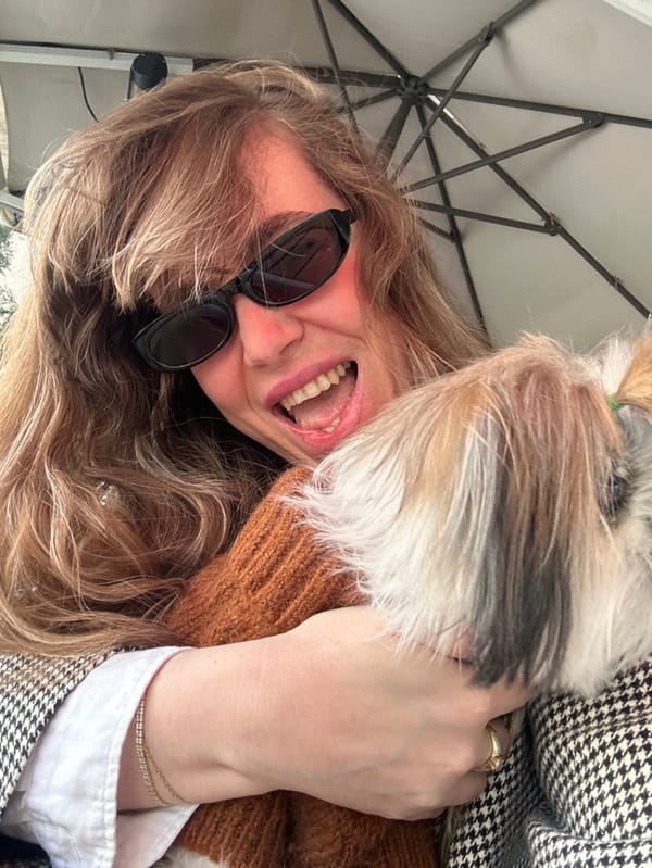 Woman and dressed dog enjoy leisurely cafe morning in Tbilisi