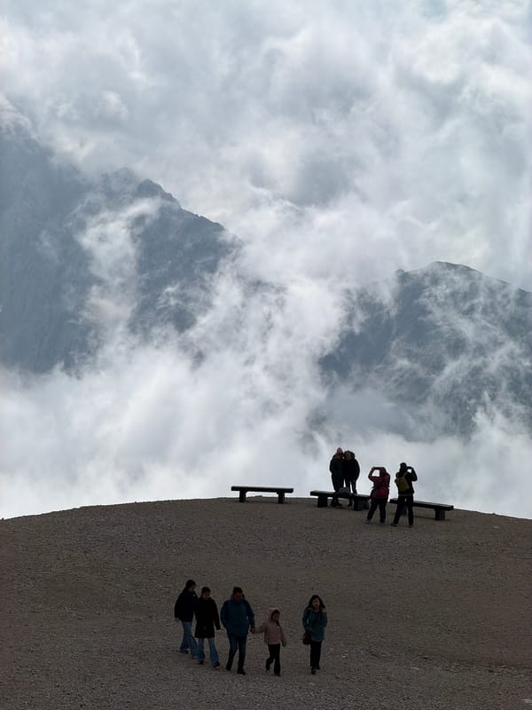 Group pauses on a cloud-wrapped alpine ridge in Wildermieming