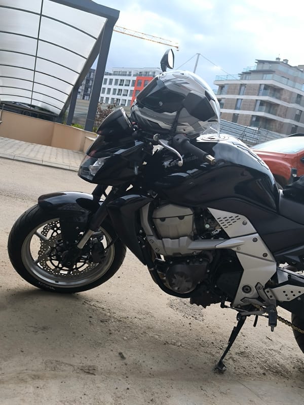 Black Kawasaki motorcycle with helmet observed parked in Sofia