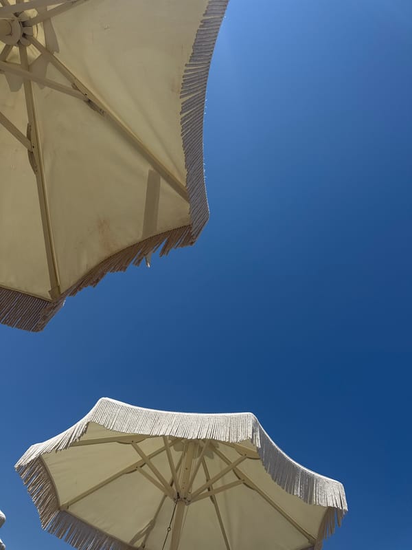 Lazy summer afternoon on a Greek beach with book and shade