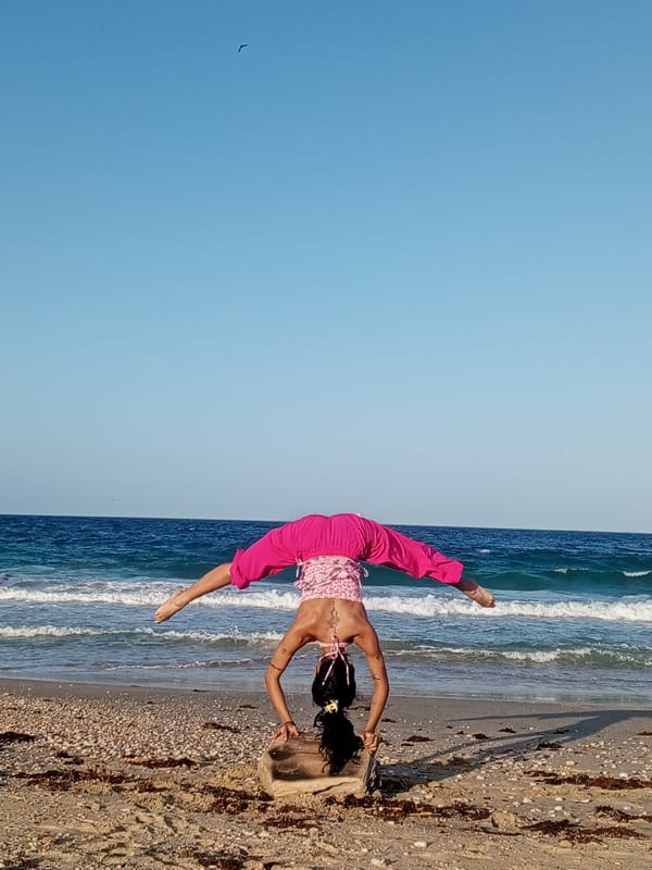 Woman performs beach yoga handstands in Porlamar, Venezuela