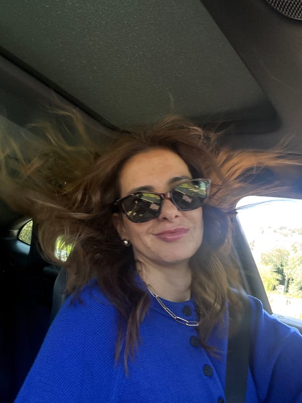 Woman in blue sweater travels by car in Torres Vedras