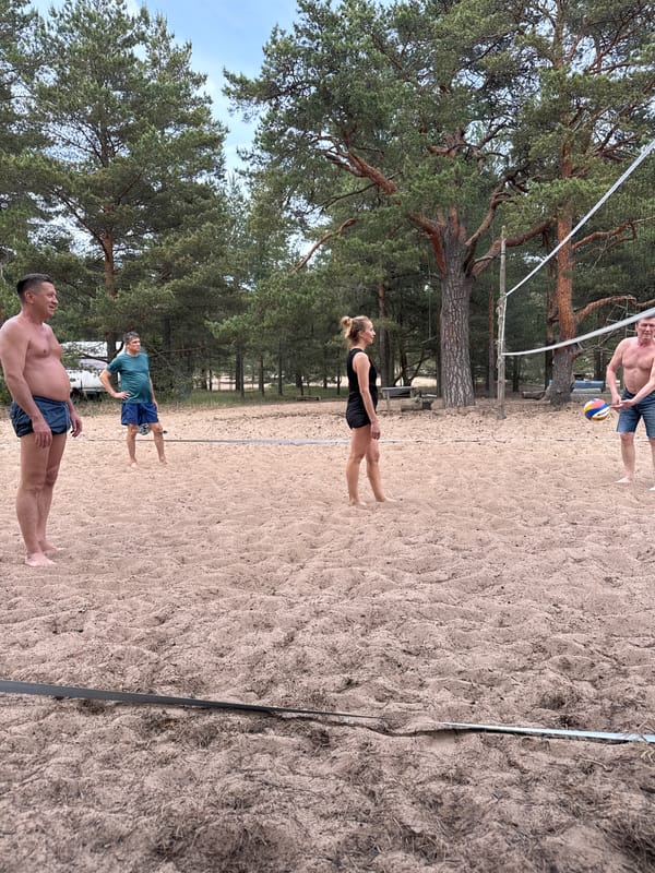 Beach volleyball players gather at forest court in Russia